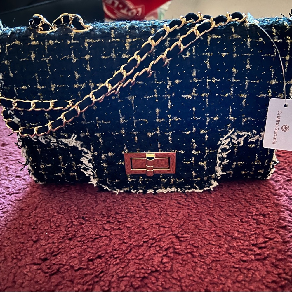 Fabric covered purse with gold chain handle.